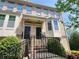 Brick townhouse with a covered entrance and decorative bay window; well maintained landscaping at 10650 Allon Cv # 137, Alpharetta, GA 30022