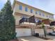 Exterior view of townhomes with balconies and garages at 10650 Allon Cv # 137, Alpharetta, GA 30022