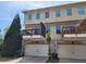 Townhouse with balcony, garages, and well-maintained landscaping in a residential area at 10650 Allon Cv # 137, Alpharetta, GA 30022