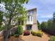 Multi-story home with bay windows, brick facade, landscaped yard and lush green trees at 10650 Allon Cv # 137, Alpharetta, GA 30022