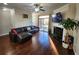 Cozy living room with hardwood floors, fireplace, and access to outdoor deck at 10650 Allon Cv # 137, Alpharetta, GA 30022