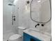 Modern bathroom features glass shower, white marble and blue vanity at 293 Ormond Se St, Atlanta, GA 30315