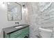 Bathroom with stylish vanity, stone backsplash, toilet, and modern fixtures at 293 Ormond Se St, Atlanta, GA 30315