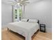 A bright bedroom featuring a king bed, hardwood floors, and a ceiling fan at 293 Ormond Se St, Atlanta, GA 30315