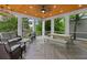 Relaxing covered patio with ceiling fan, lounge seating, and dining area overlooking a lush green space at 293 Ormond Se St, Atlanta, GA 30315