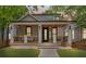Charming home boasts a welcoming porch, manicured lawn, and craftsman details at 293 Ormond Se St, Atlanta, GA 30315