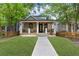 Charming home boasts a welcoming porch, manicured lawn, and craftsman details at 293 Ormond Se St, Atlanta, GA 30315