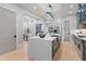 Gourmet kitchen features large island, stainless appliances and gray cabinets with open floor plan at 293 Ormond Se St, Atlanta, GA 30315
