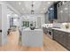Gourmet kitchen features large island, stainless appliances and gray cabinets with open floor plan at 293 Ormond Se St, Atlanta, GA 30315