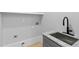 A laundry room with utility sink, black faucet, and ample space for appliances at 293 Ormond Se St, Atlanta, GA 30315