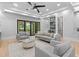 Bright living room with a ceiling fan, wood floors and sliding glass doors to outdoor living space at 293 Ormond Se St, Atlanta, GA 30315