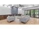 Bright living room with a fireplace, ceiling fan, wood floors and sliding glass doors to outdoor living space at 293 Ormond Se St, Atlanta, GA 30315