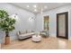 Bright living room with a modern sofa, accent chair, and stylish lighting fixtures at 293 Ormond Se St, Atlanta, GA 30315