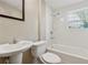 A bathroom with a white sink, toilet, and bath tub with shower at 3510 Riviera Dr, Cumming, GA 30041