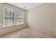 Bright bedroom showcasing neutral walls, plush carpet, and a large window at 3510 Riviera Dr, Cumming, GA 30041