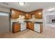A kitchen with oak cabinets, a white oven, and a double basin stainless steel sink at 3510 Riviera Dr, Cumming, GA 30041