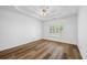 Spacious bedroom featuring tray ceilings, a ceiling fan, a window with blinds, and beautiful wood-look flooring at 4368 Magnolia Bay Ln, Snellville, GA 30039