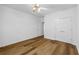 This bright bedroom features wood-look floors and a ceiling fan with lighting at 4368 Magnolia Bay Ln, Snellville, GA 30039