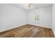 Bedroom with wood-look floors, a window, white trim, and a modern ceiling fan with lighting at 4368 Magnolia Bay Ln, Snellville, GA 30039