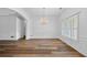Elegant dining room with hardwood floors, wainscoting, a large window, and an elegant chandelier at 4368 Magnolia Bay Ln, Snellville, GA 30039