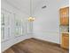 Dining room features wood floors, natural light, and chandelier lighting at 4368 Magnolia Bay Ln, Snellville, GA 30039
