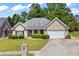 Charming single-story brick home featuring a two-car garage, well-manicured lawn, and established landscaping at 4368 Magnolia Bay Ln, Snellville, GA 30039