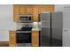 Kitchen featuring wood cabinets, stainless steel appliances, and a tiled backsplash at 4368 Magnolia Bay Ln, Snellville, GA 30039
