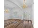 Bright and airy living room with hardwood floors, large windows and elegant lighting, offering a versatile space at 4368 Magnolia Bay Ln, Snellville, GA 30039