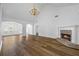 Bright living room with a fireplace, wood floors, vaulted ceiling, and chandelier lighting at 4368 Magnolia Bay Ln, Snellville, GA 30039