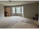 Living room with large windows, neutral paint, and adjacent area with cabinets at 4447 Lake Breeze Dr, Stone Mountain, GA 30083