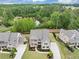 An aerial view of a beautifully landscaped home with a private backyard overlooking a serene pond at 5075 Briarstone Ridge Way, Alpharetta, GA 30022