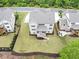Aerial shot of a gray home with a backyard deck, fence, and nicely manicured lawn at 5075 Briarstone Ridge Way, Alpharetta, GA 30022