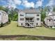 Well-manicured lawn and backyard featuring an elevated deck on this charming residence at 5075 Briarstone Ridge Way, Alpharetta, GA 30022