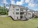Nice home featuring a well-kept lawn, an elevated deck, and a brick-accented foundation at 5075 Briarstone Ridge Way, Alpharetta, GA 30022