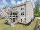 Attractive home exterior features a brick foundation, a deck, and a well-maintained lawn at 5075 Briarstone Ridge Way, Alpharetta, GA 30022