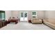 Bright, finished basement with a seating area, table and ping pong table and walk-out access at 5075 Briarstone Ridge Way, Alpharetta, GA 30022
