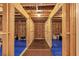 Unfinished basement framed with wooden studs and covered with protective blue tarps at 5075 Briarstone Ridge Way, Alpharetta, GA 30022