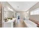 Spacious bathroom with double vanities, soaking tub, and tile flooring at 5075 Briarstone Ridge Way, Alpharetta, GA 30022