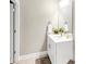 Neat half bath features a white vanity, sleek mirror, and modern fixtures at 5075 Briarstone Ridge Way, Alpharetta, GA 30022