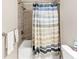 Well-lit bathroom featuring a shower with curtain, updated fixtures, and a neutral color palette at 5075 Briarstone Ridge Way, Alpharetta, GA 30022