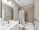 Stylish bathroom showcasing tiled shower, tub combo, white vanity and sink at 5075 Briarstone Ridge Way, Alpharetta, GA 30022