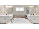 Bathroom featuring dual vanities, a soaking tub, and elegant lighting at 5075 Briarstone Ridge Way, Alpharetta, GA 30022