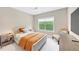 Bright bedroom with large window, neutral walls, and modern furnishings at 5075 Briarstone Ridge Way, Alpharetta, GA 30022
