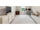 Bedroom with neutral walls, carpet flooring, a window, modern desk, cabinet, and office chair at 5075 Briarstone Ridge Way, Alpharetta, GA 30022