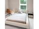 Clean, modern bedroom features a platform bed, large window, and minimalist decor at 5075 Briarstone Ridge Way, Alpharetta, GA 30022
