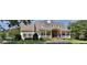 Beautiful clubhouse with American flag, portico entry, stone facade, and attractive landscaping at 5075 Briarstone Ridge Way, Alpharetta, GA 30022