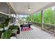 Cozy covered porch with outdoor seating and views of the surrounding lush greenery at 5075 Briarstone Ridge Way, Alpharetta, GA 30022