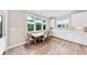 Bright breakfast nook featuring a modern table, chairs, and large windows at 5075 Briarstone Ridge Way, Alpharetta, GA 30022