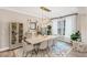 Spacious dining room with modern decor, seating for eight, and ample natural light at 5075 Briarstone Ridge Way, Alpharetta, GA 30022