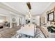 Large dining area with modern table, chairs, and adjacent living space for entertaining at 5075 Briarstone Ridge Way, Alpharetta, GA 30022